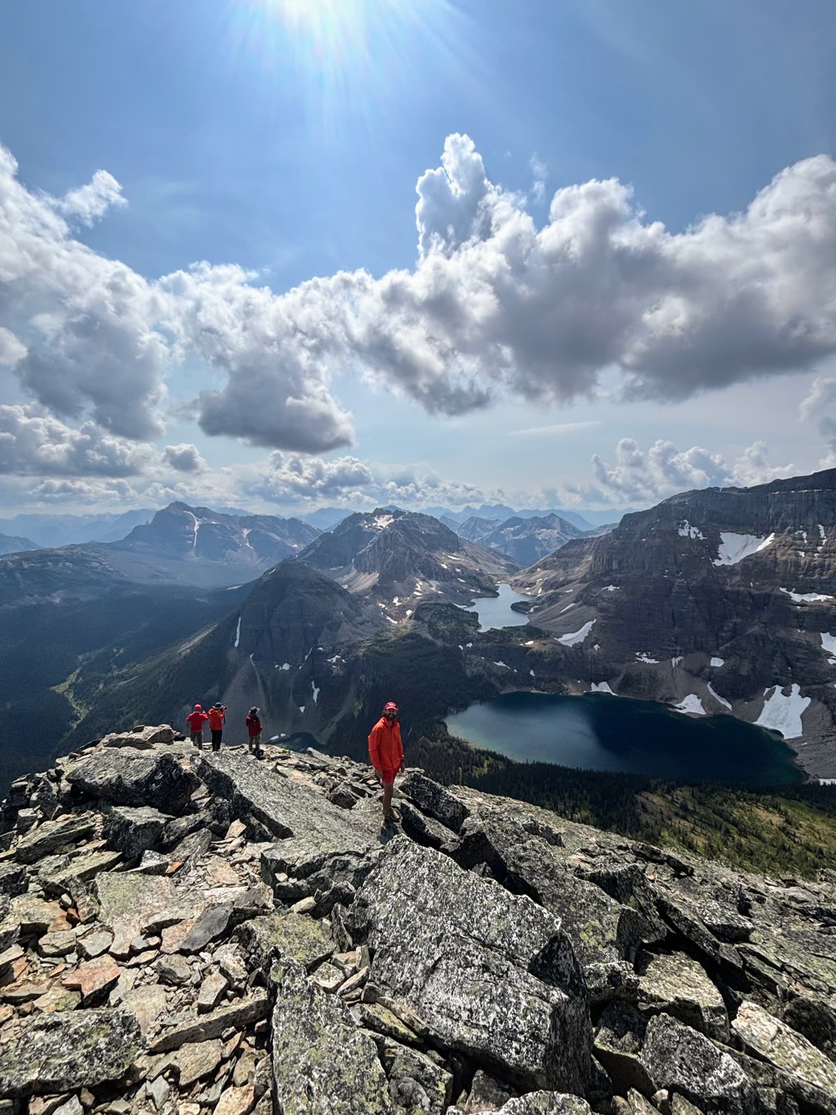 Connect'd Men members on the rocky summit of Pharaoh Peak, above a mountain lake