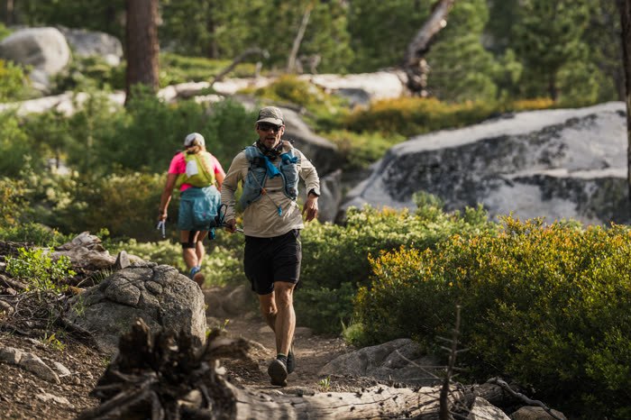 Two trail runners on the same rocky mountain path